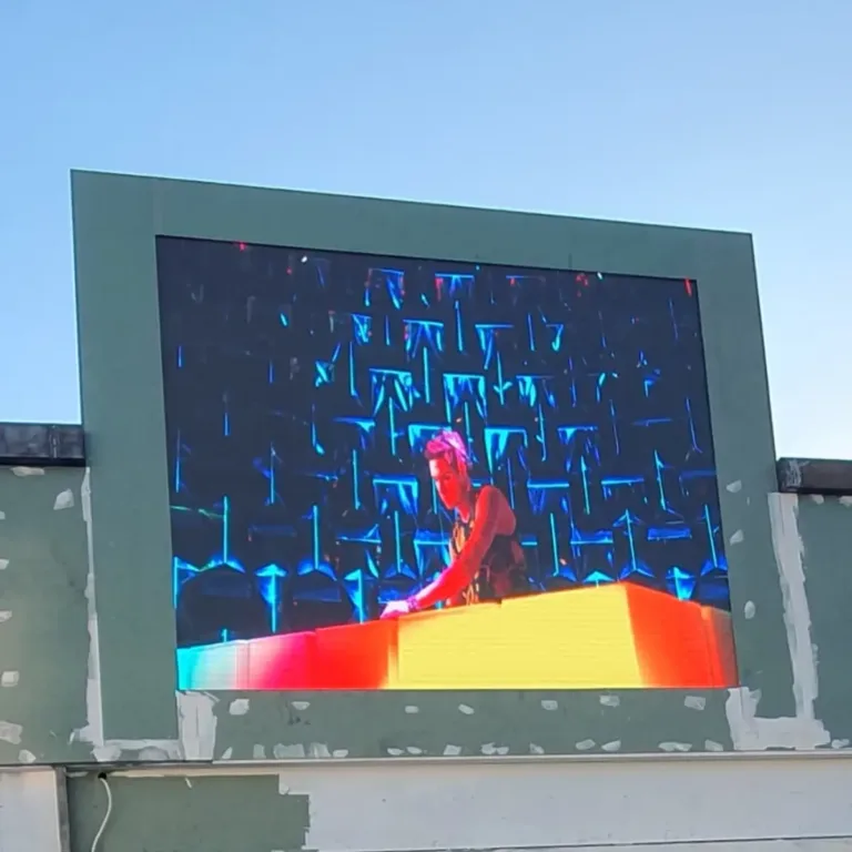 Roof-mounted outdoor LED screen displaying vibrant visuals on building
