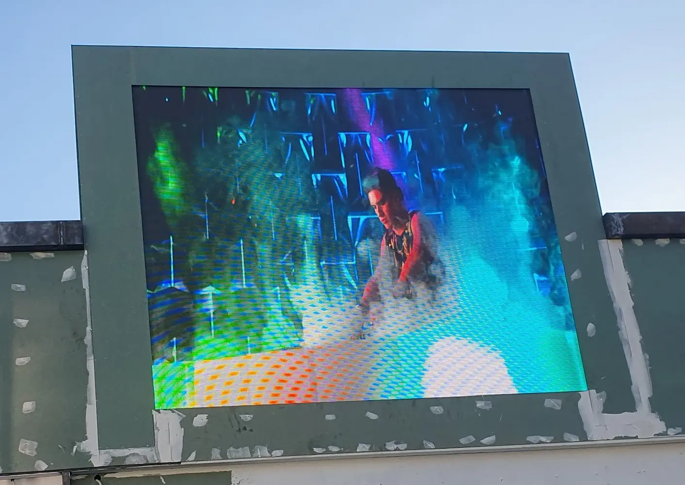 Outdoor LED display screen showing man in action