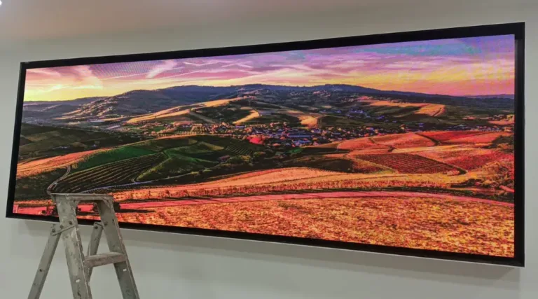 Digital display screen mounted on wall showing vibrant colors