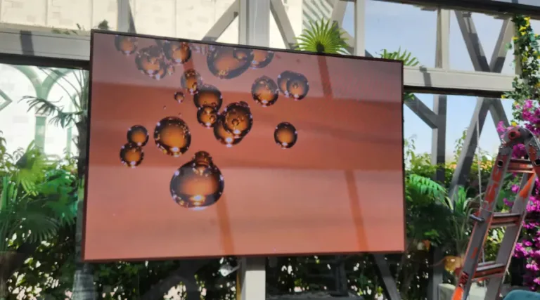 Outdoor LED video display showing refreshing water droplets