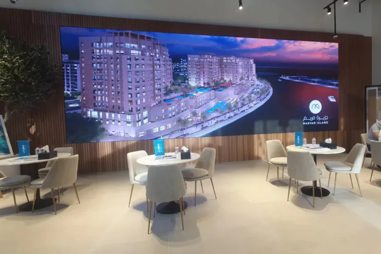 Large indoor LED screen displaying beach view