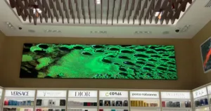 Custom LED display in perfume store surrounded by shelves