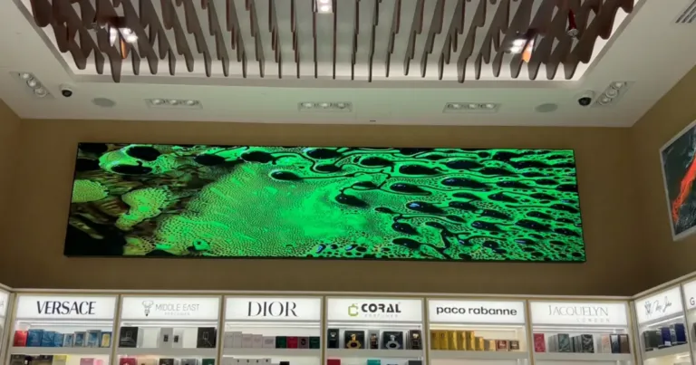Custom LED display in perfume store surrounded by shelves