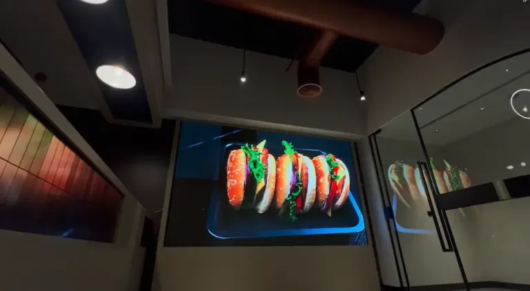 Indoor LED display screen showing a taco on a plate