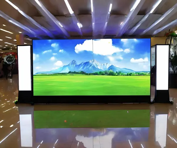 Indoor LED advertising screen displaying a colorful natural landscape
