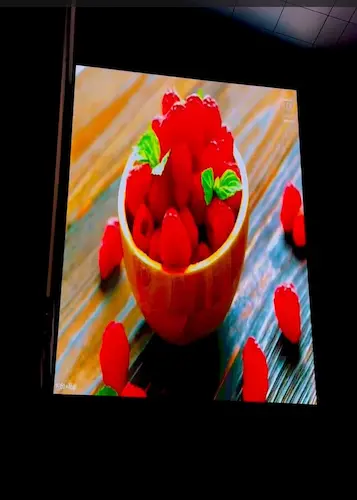outdoor LED video display showing vibrant raspberry bowl visual