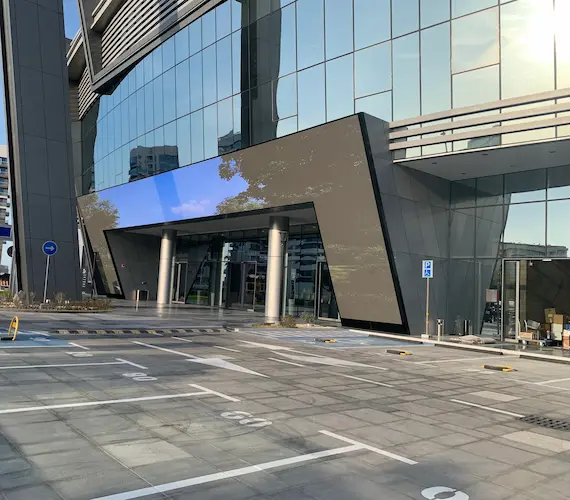 Outdoor LED screen displaying content in front of building