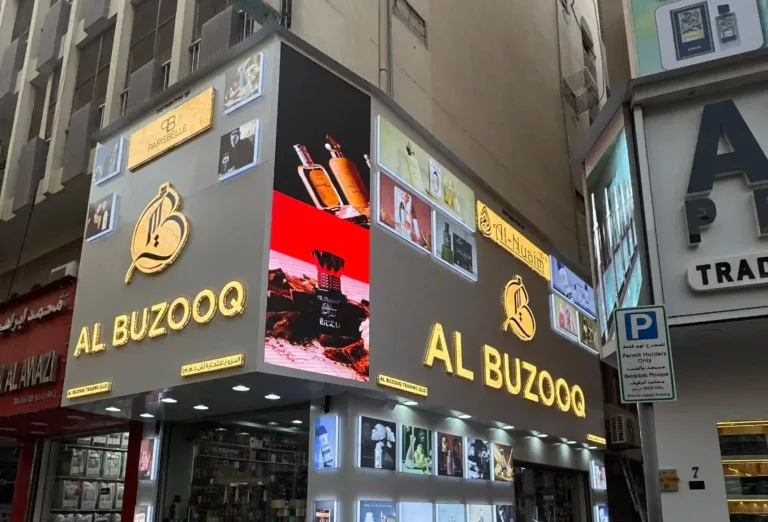 Outdoor LED screen displaying Al Buzooq logo at retail store