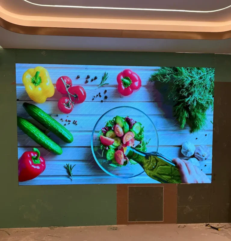 Indoor LED screen displaying colorful fruits and vegetables