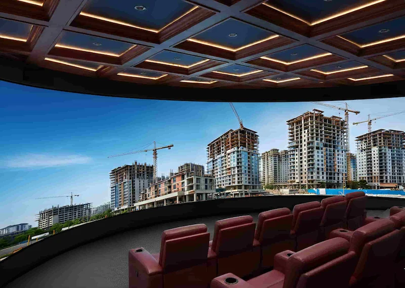 Curved LED display in movie theater showing city skyline