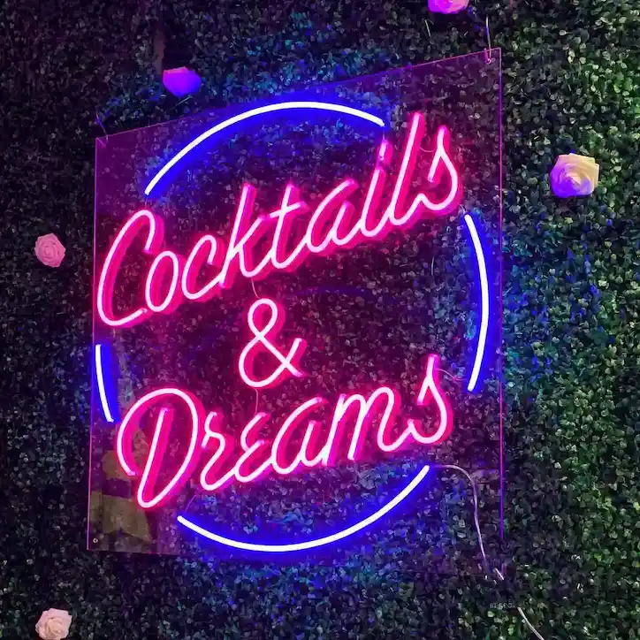 Neon signage displaying 'cocktails and dreams' text
