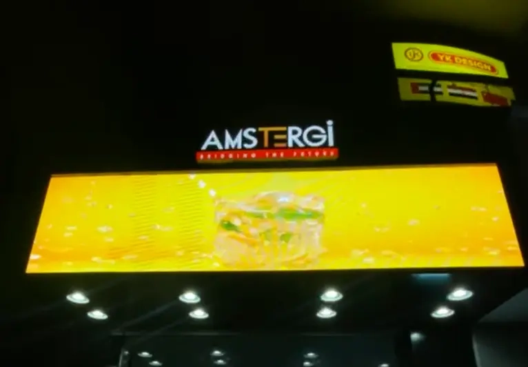 Storefront LED display screen showing shop name "Amstergi"
