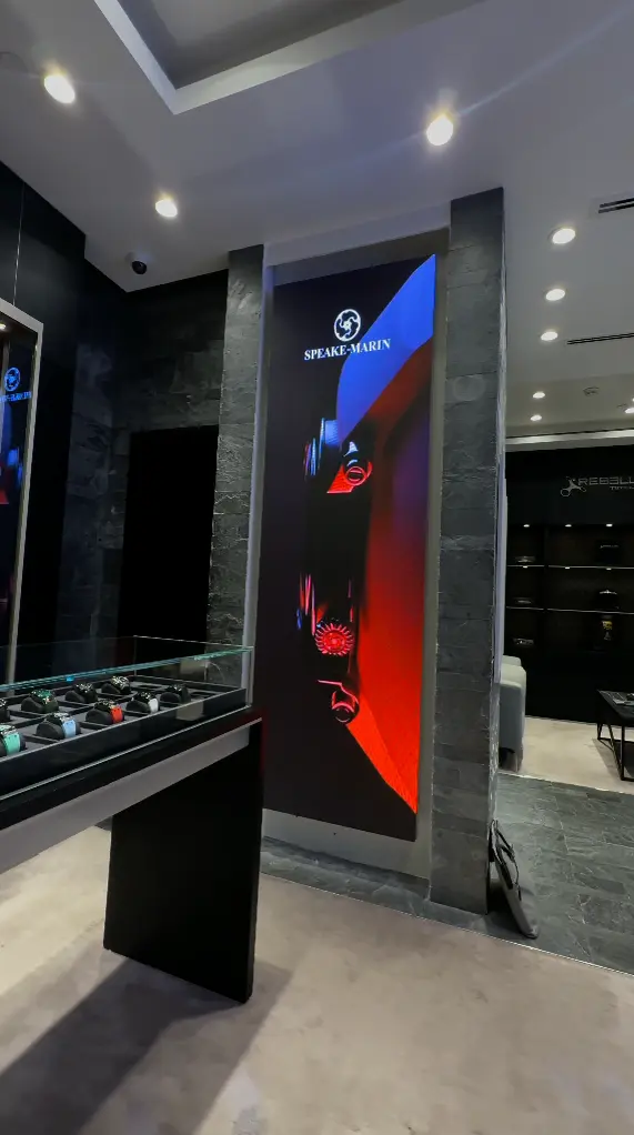 Watch store LED screen on wall showing current offers