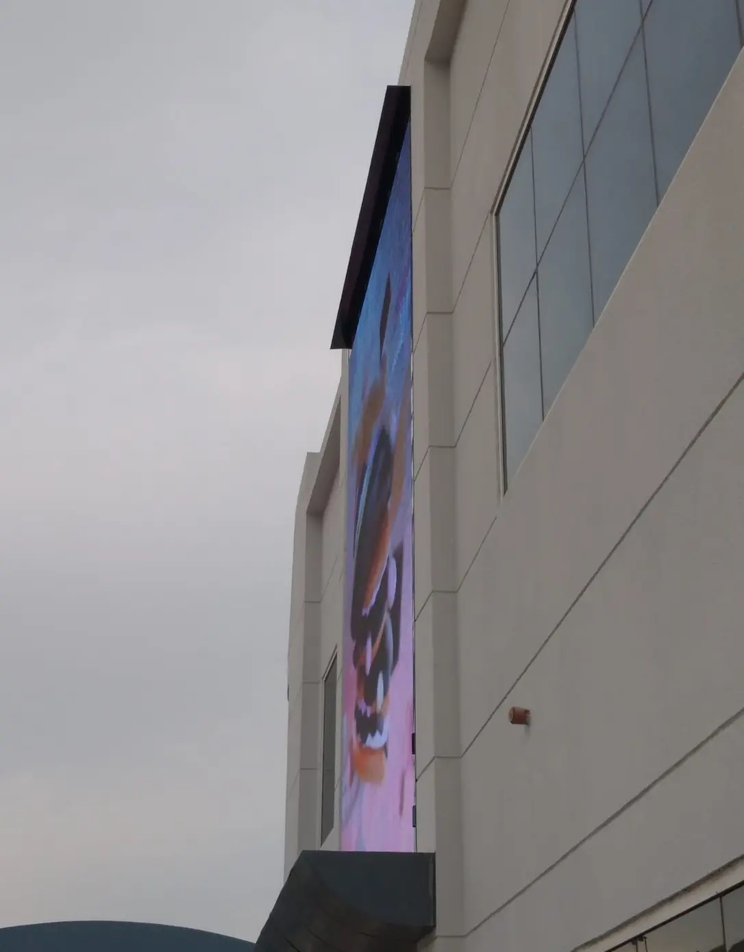 Outdoor digital signage screen on building facade with dynamic visuals